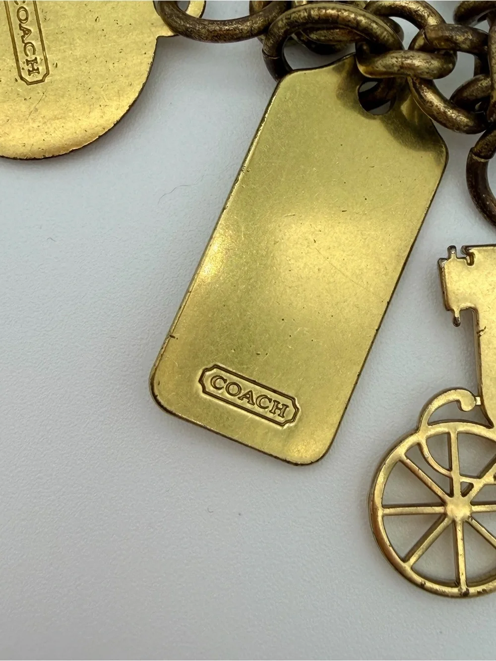 COACH Brass Charm Bracelet with Coach Tags & Horse Carriage Charm